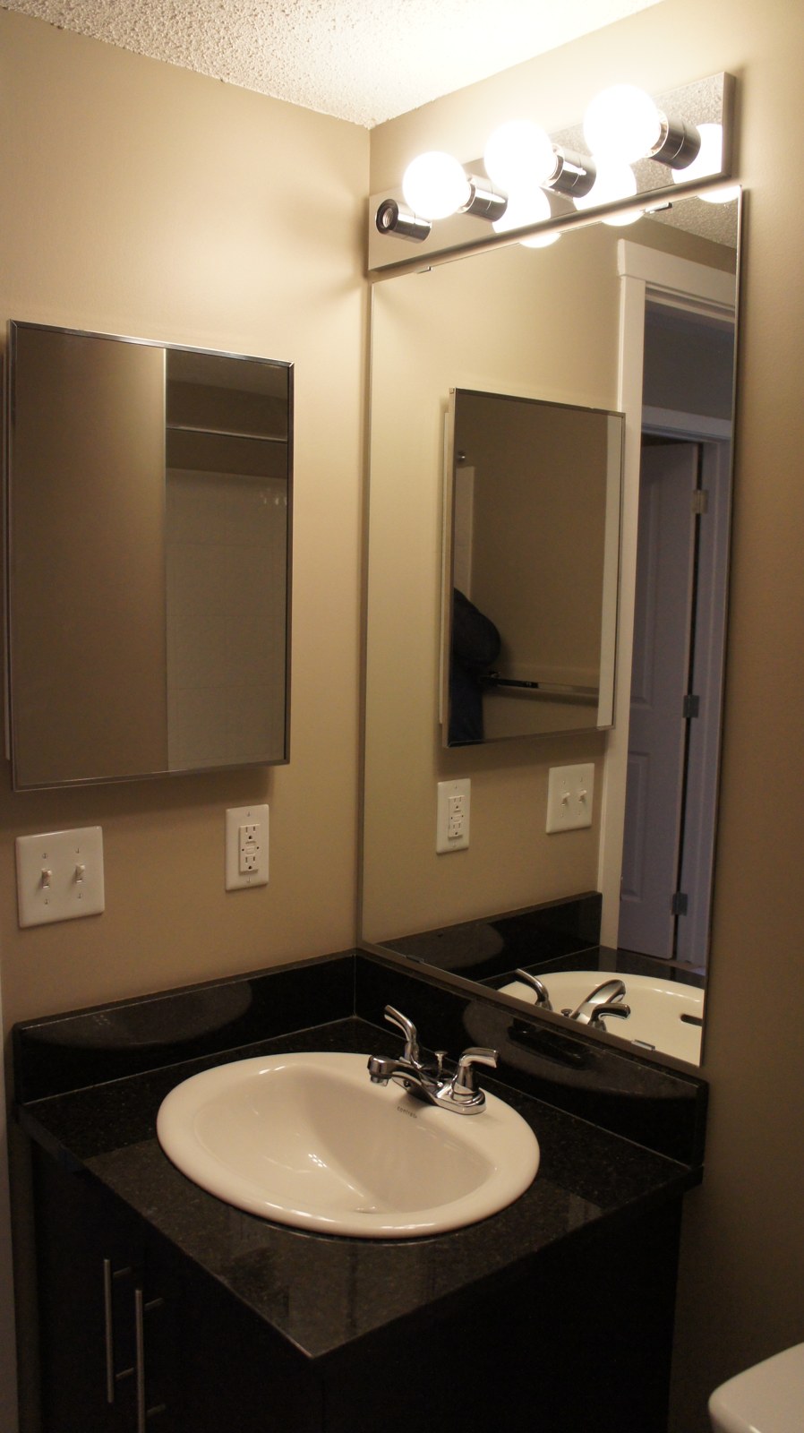 Bathroom vanity with studio lit mirror